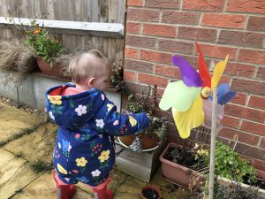 Eleanor exploring the plants in the garden